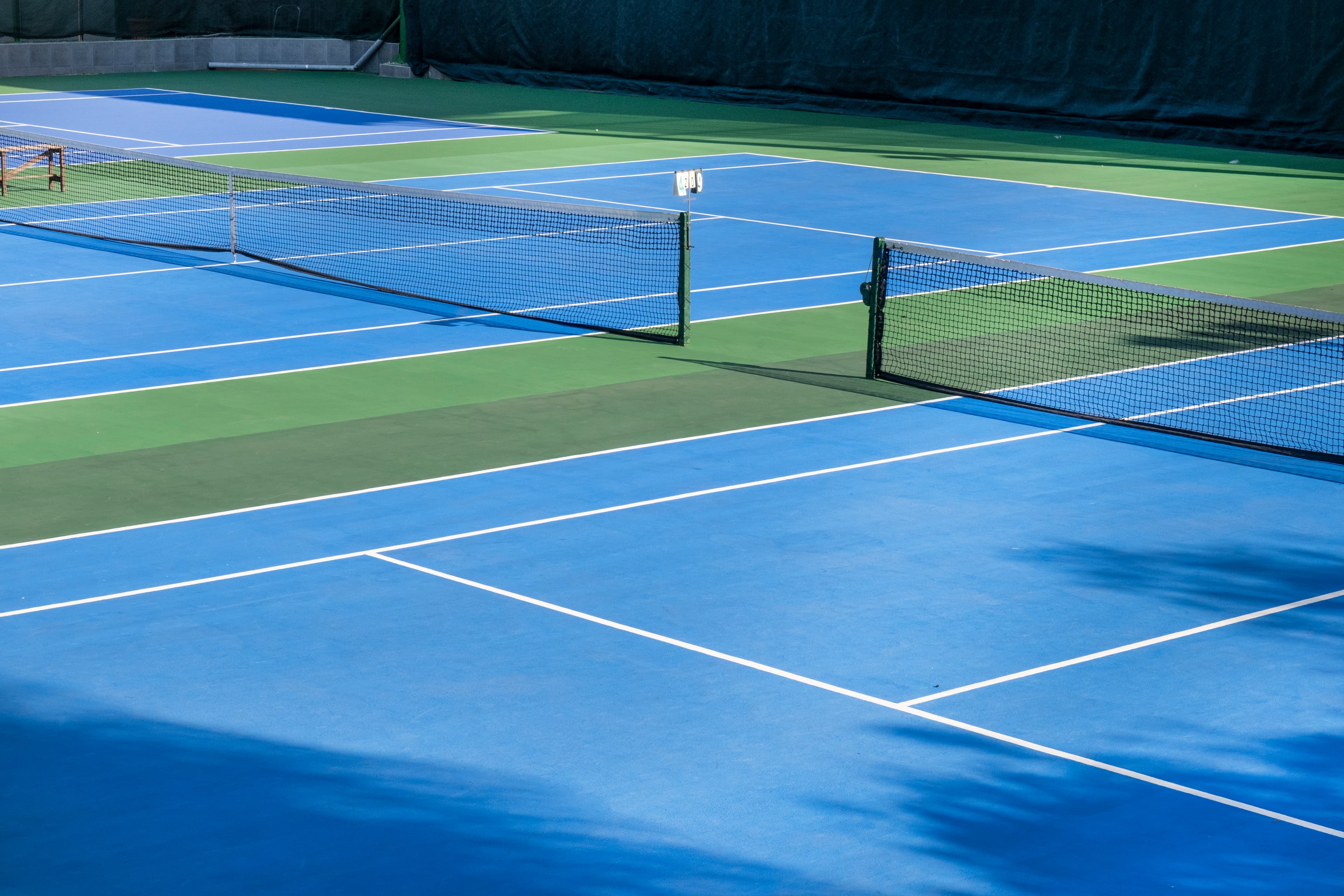 Multiple blue and green tennis courts
